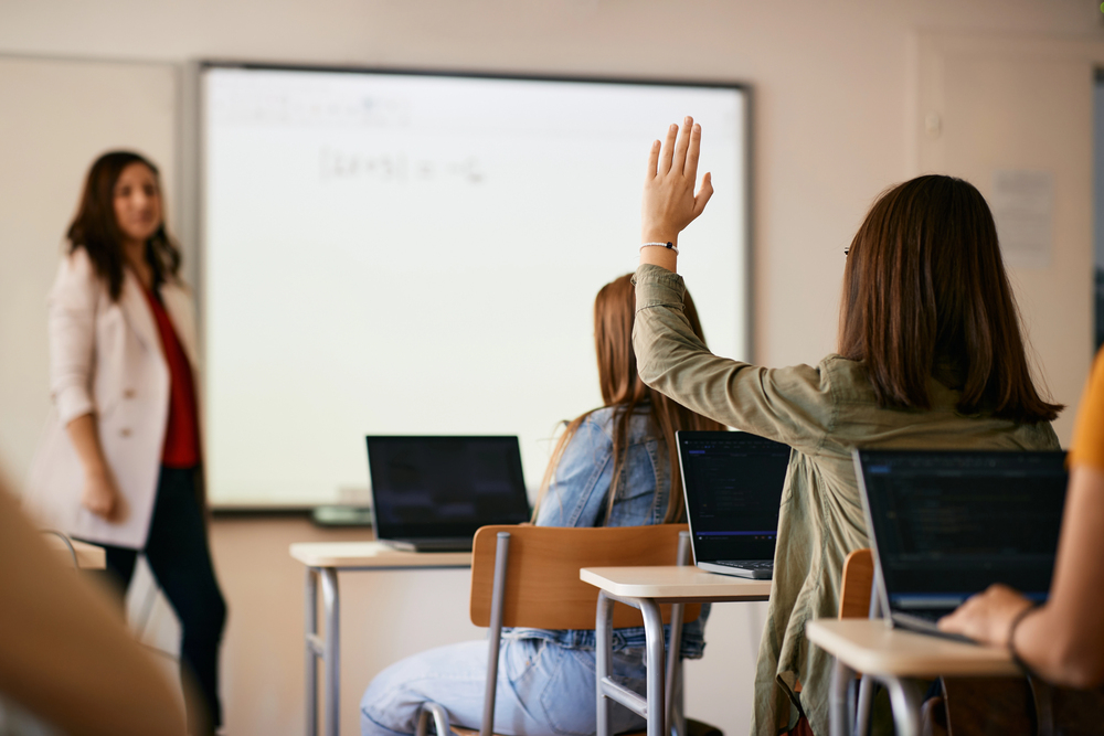 Teenage Girl Raising Her Hand Answer Question